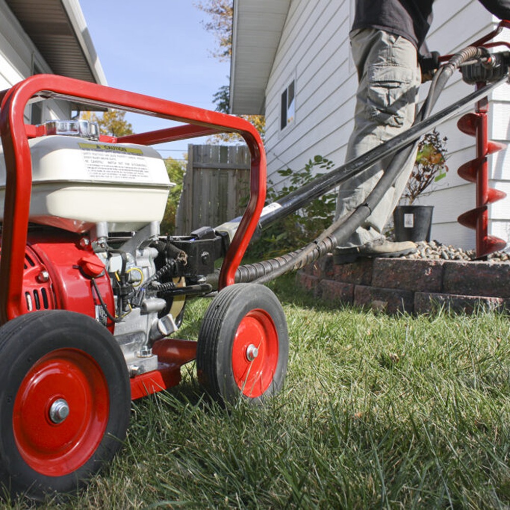 man landscaping with earth drill