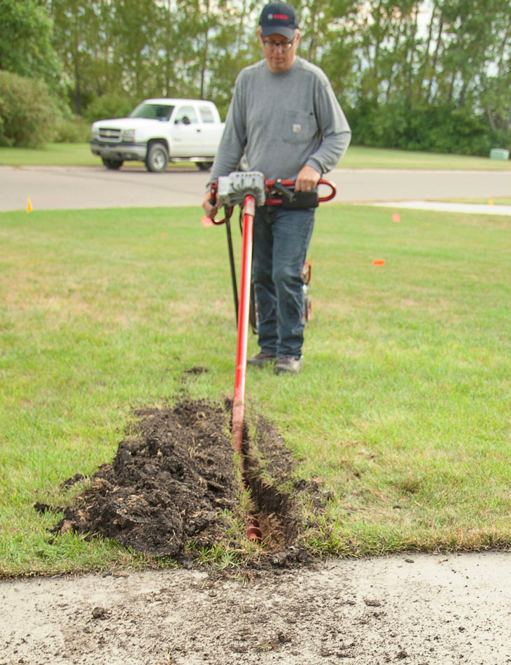 Man Using Horizontal Sidewalk Boring Kit