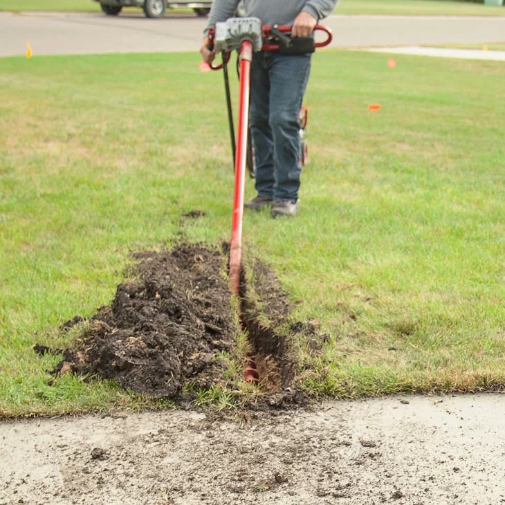 Man Using Horizontal Sidewalk Boring Kit