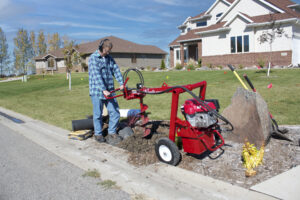 man drilling mailbox hole